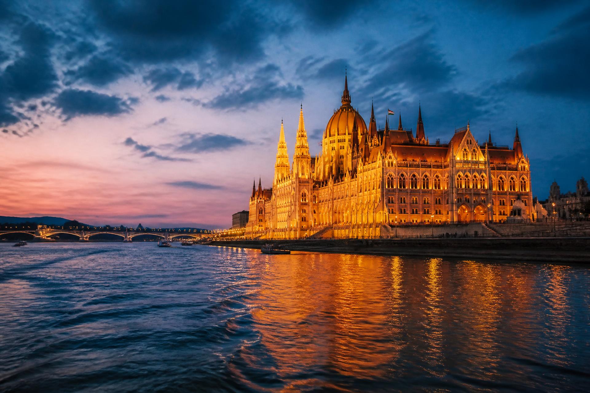 Hungarian Parliament illuminated at twilight over the Danube